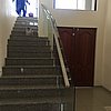 Frameless Glass Floor Mount on stairs from the bottom.JPG