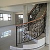 Wrought Iron with Wooden Balustrade Staircase curved.JPG