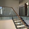 Two Stringer Staircase with Two Landings wooden handrail on glass.JPG